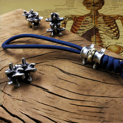 Disc Goblin – Anatomical Spine Knife Bead | Bronze and White Brass EDC Paracord Bead with Grinning Disc Face